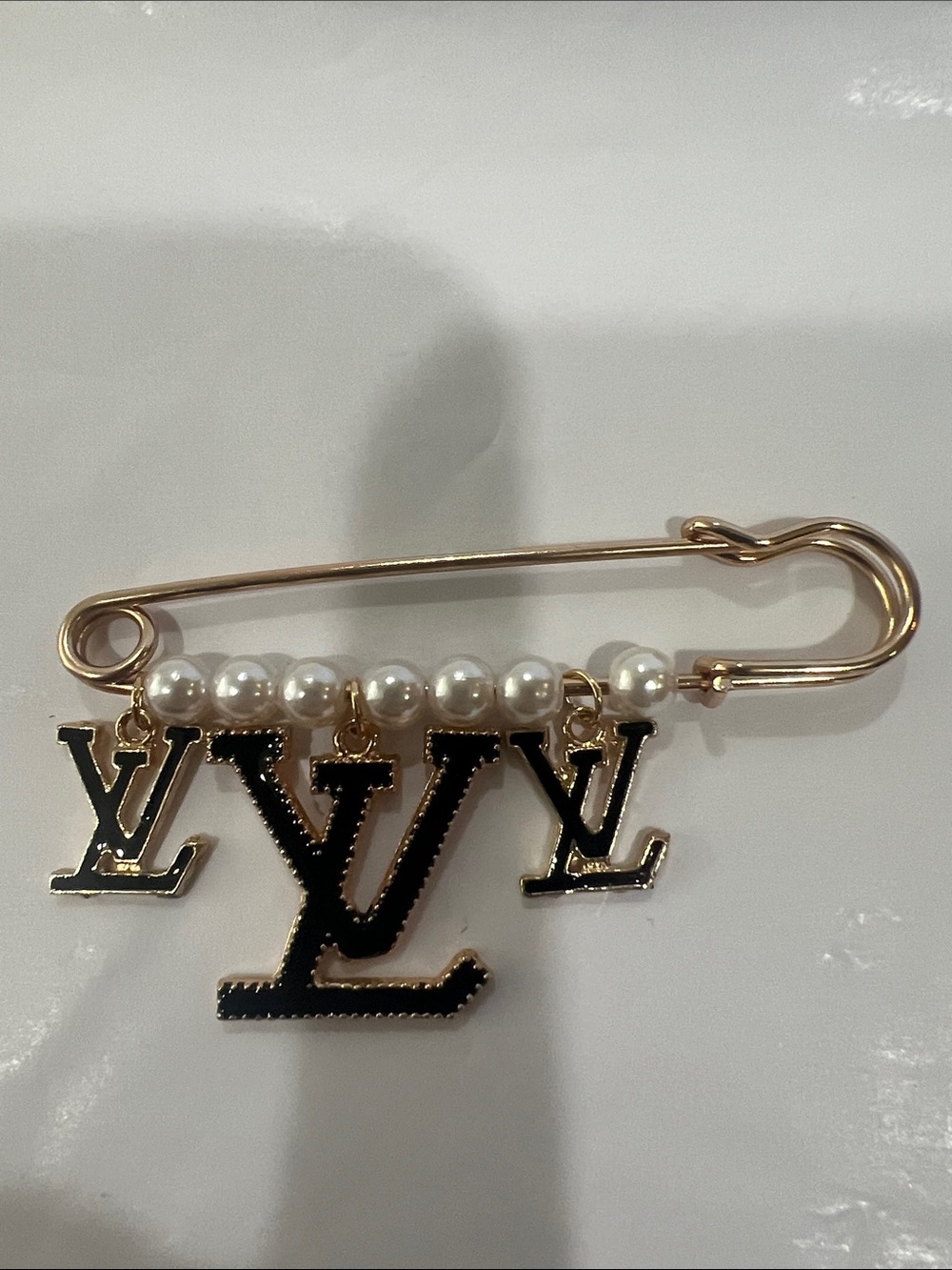 LV collection Gold-Tone Pearl Safety Pin Brooch with Black LV Charms